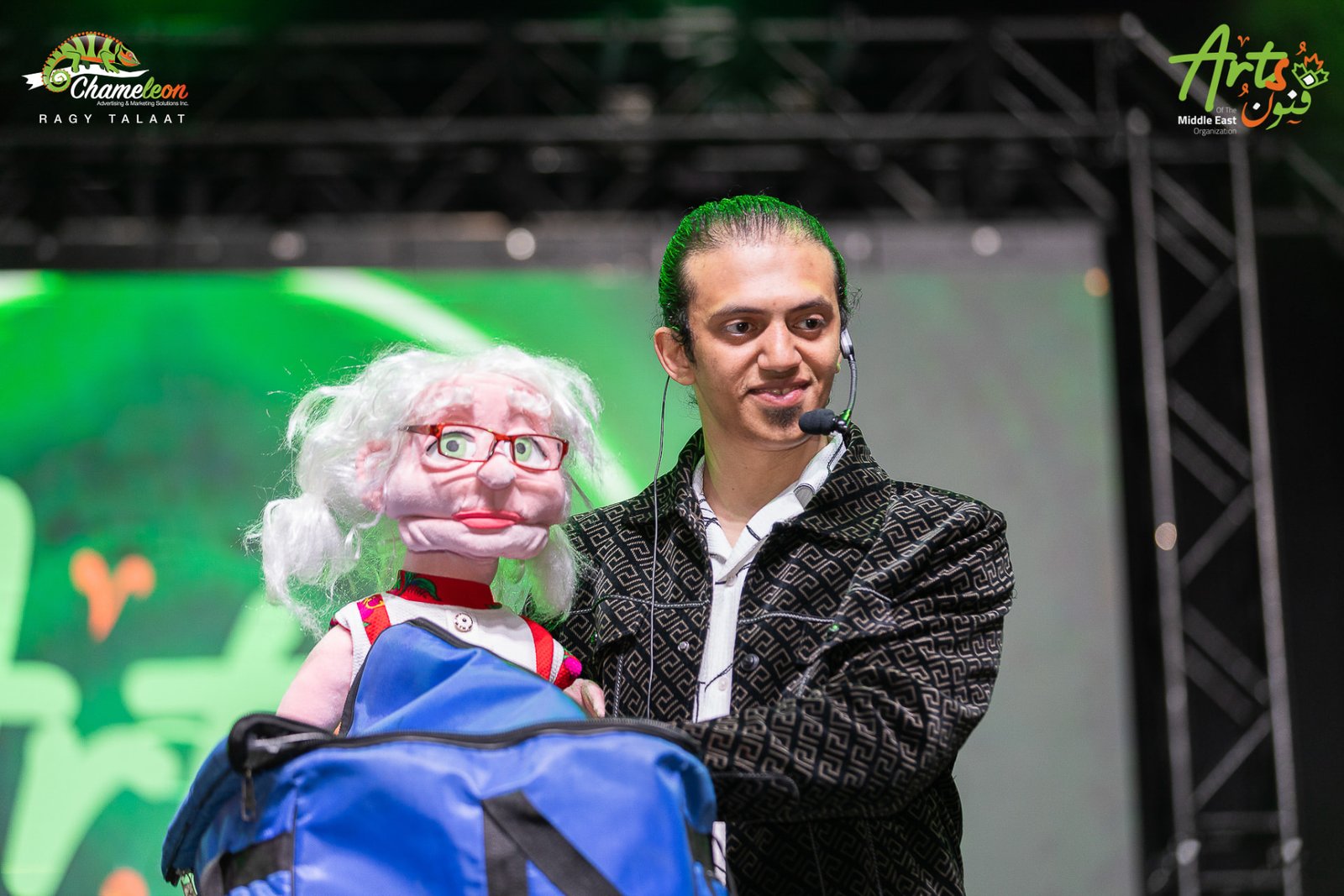 Abanob Flex performing with a grandmother puppet on stage