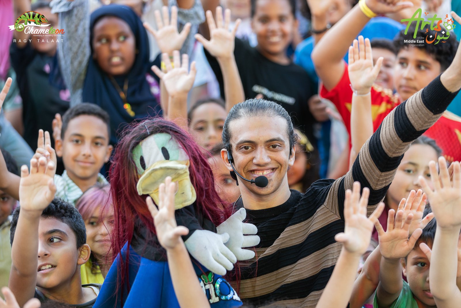 Puppeteer surrounded by cheering children at AMEF 2
