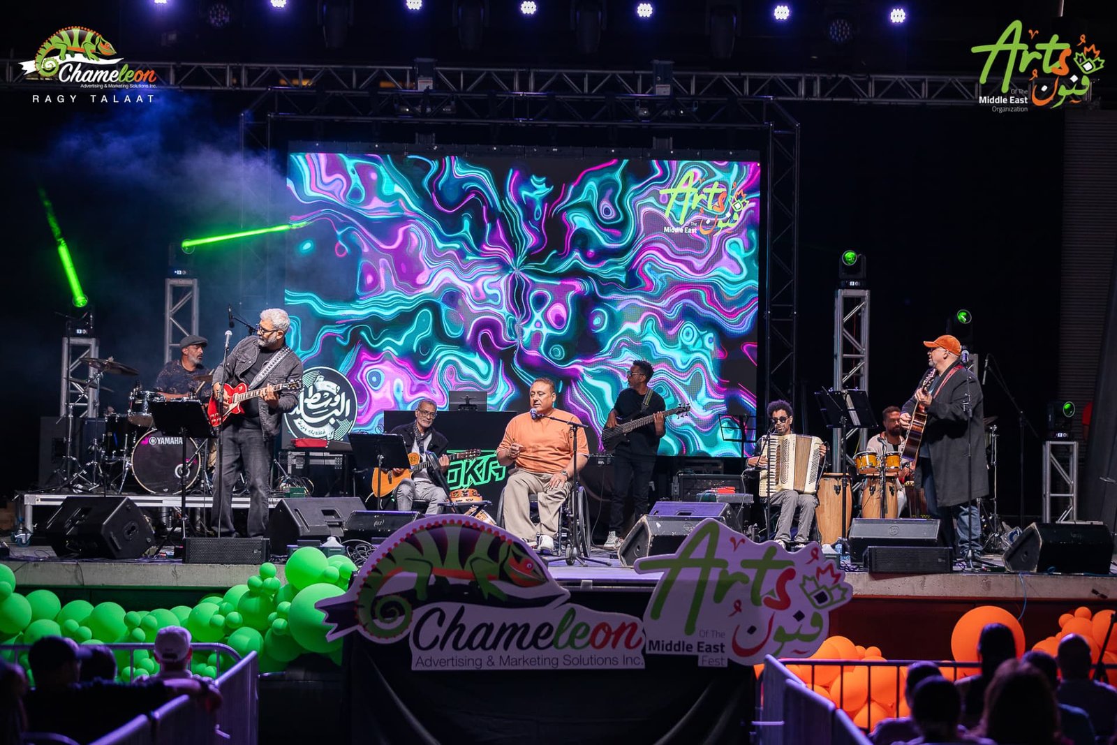 The seated ensemble performing on stage